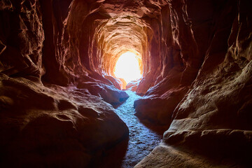 Sandstone Cave Interior with Sunlit Entrance and Textured Walls