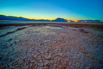 Cracked Earth and Distant Mountains at Boulder City Dry Lake Bed Golden Hour