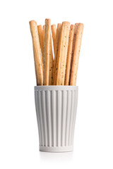 Crispy grissini breadsticks in cup isolated on white background.