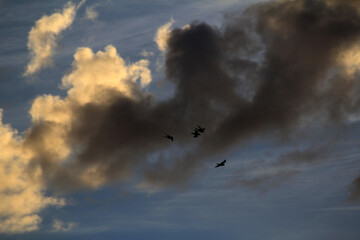A striking contrast of light and shadow across the clouds