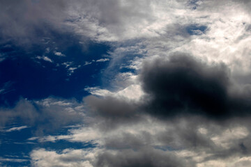 Dramatic clouds against a bright blue sky