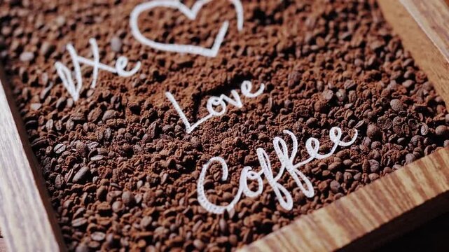 Milled coffee beans positioned in timber container, affection for coffee cardiac symbol sketched in deep brown granules, pictured throughout coffee excursion