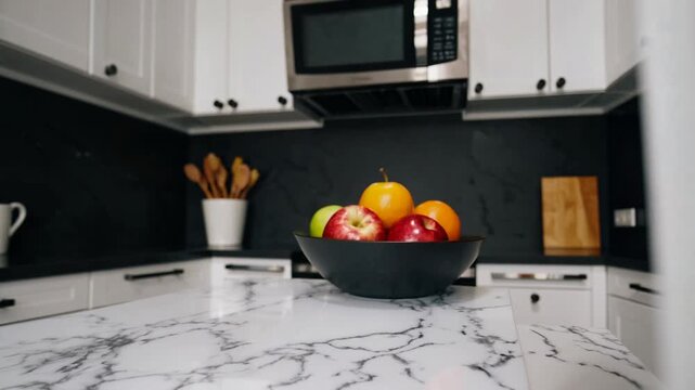 Contemporary newly illuminated internal area of kitchen equipped with white cabinetry