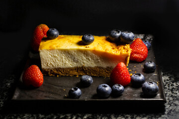 Sweet dessert with berries on a dark background