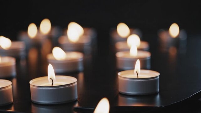 Burning Candles on Black Table Holocaust Memory Day