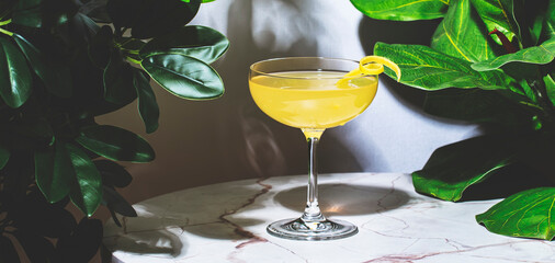 Monte Cassino, yellow alcoholic cocktail drink with whiskey, liqueur and lemon juice. Marble table...
