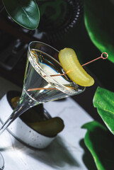 Cajun Martini alcohol cocktail drink with vodka, jalapeno pepper, dry vermouth and pickle with bar...