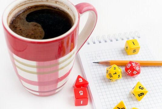 Dices for rpg, dnd or board games, notebook, pencil and a mug of coffee.