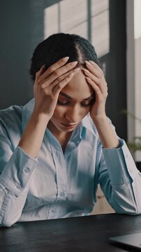 Exhausted multitasking executive director at workplace, feeling headache after online work on laptop
