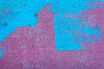 Old messy grunge wall texture background. Random blue paint strokes on pink background