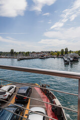Ferry approaching marina with boats and village in background