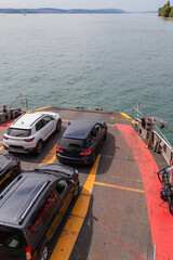 Cars parked on ferry deck crossing the lake