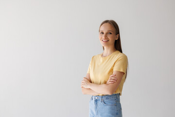 Portrait of the beautiful businesswoman with arms crossed on a white background