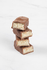 Vegan Chocolate Coconut bar. White background. Copy space	