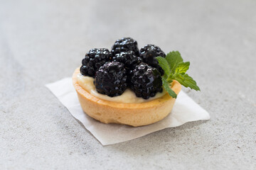 Blueberry tartlet. With custard. Light background.	