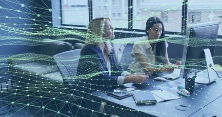 Analyzing business report, colleagues pointing at screen while viewing data lines overlaying desk - Powered by Adobe