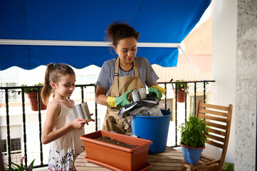 Mother and Daughter Gardening Together on a Cozy Balcony