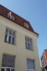 Architectural features of a yellow building under a clear blue sky in a city setting