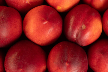Freshly harvested nectarines displayed in a market setting during late summer season