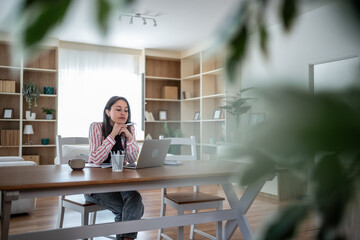 Focused freelancer working from home office using laptop