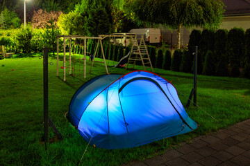 Glowing Tent at Night in a Garden – Illuminated Camping Scene with Cozy Atmosphere