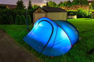 Glowing Tent at Night in a Garden – Illuminated Camping Scene with Cozy Atmosphere