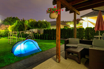 Glowing Tent at Night in a Garden – Illuminated Camping Scene with Cozy Atmosphere