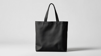 Black tote bag standing on white background for shopping or groceries