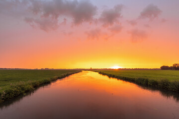 Orange sunset over Dwingelder Stroom river