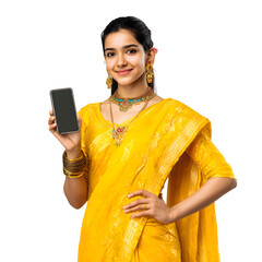 Young woman in vibrant yellow sari and traditional jewelry smiles confidently while holding a smartphone.