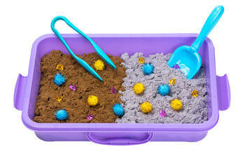 Kinetic sand of two colors with pompoms, stones, scoop and tongs in plastic container isolated on...