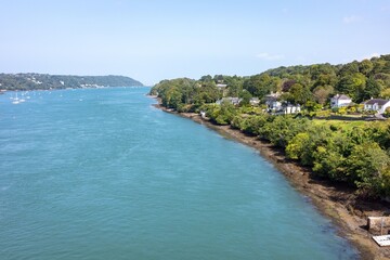 Menia Straits between Anglesey and north Wales with distant sailboats on a clear day.