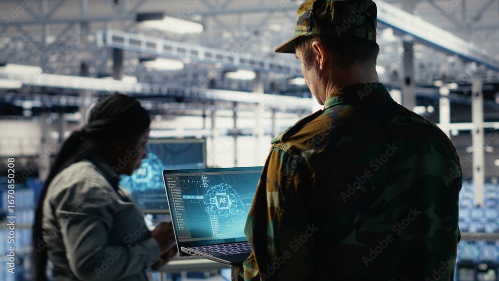 Poster soldier in engineering role uses ai application on laptop to manage server hub systems. army command