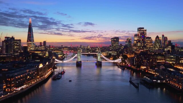 London Skyline Aerial Pullback Reveal of Tower Bridge and City Lights at Sunset