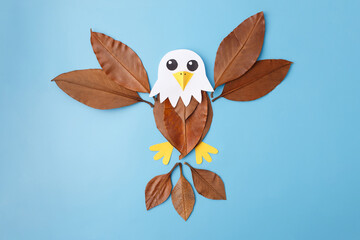 autumn eagle applique made of leaves, abstract bird collage for children craft project, perfect for eco workshops, publishing, education platforms, folk art collections and design materials,