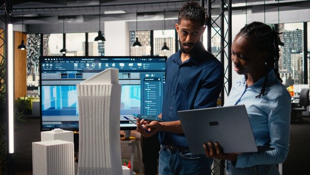 Middle eastern real estate developer presenting idea of residential layout, discussing about housing and urban development master plan with his colleagues. Property investment.