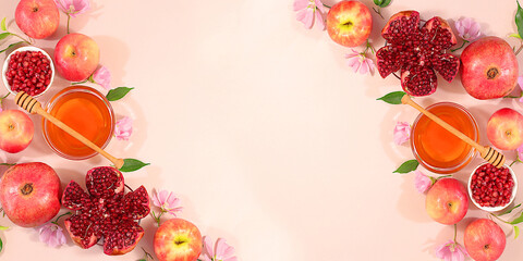 Autumn banner with honey, apples, pomegranates, flowers, dried fruits for holiday greeting, composition for Jewish holiday Rosh Hashanah with traditional symbols, creative layout for design, template