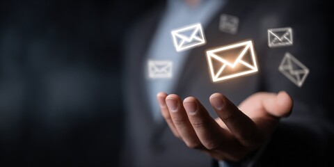 Hand holding a digital email symbol