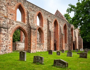 Naklejka premium Ruined church with graveyard