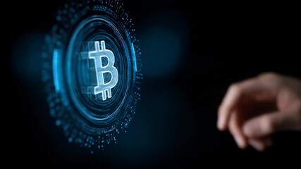 A hand interacts with a glowing digital bitcoin symbol, highlighting the concept of technology and cryptocurrency. - Powered by Adobe