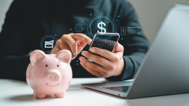 Online banking and savings concept with mobile phone piggy bank and laptop for financial growth
