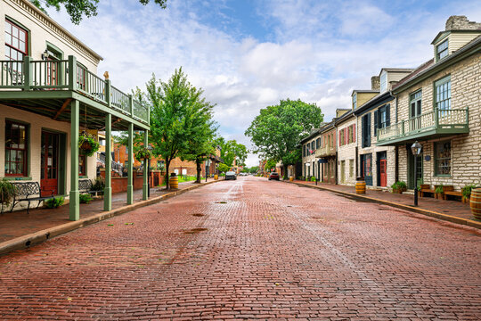 The picturesque brick paved 18th century Main Street of shops through the historic American small town of St. Charles, Missouri.