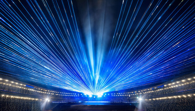 a central platform is brightly illuminated by striking blue and white lights in a grand venue the vibrant beams of light create an atmosphere of anticipation for a captivating evening performance