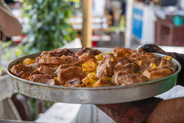 A dish of roasted meat and vegetables.