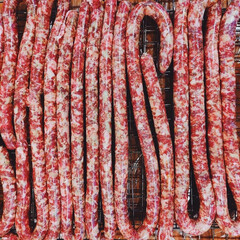 Rows of fresh sausages hanging for drying.