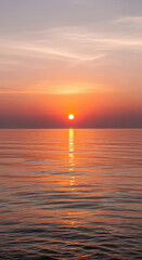 Naklejka premium Vibrant Orange Sun Setting Over Calm Water at Twilight