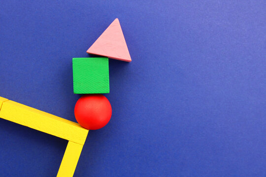 Wooden geometric figures in balance try not to fall