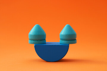 Wooden figures balanced on an arch