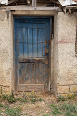 Blue door on an old stucco house.