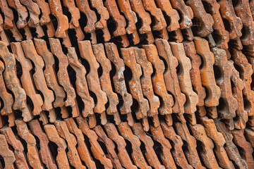Stacked red ceramic roofing tiles.